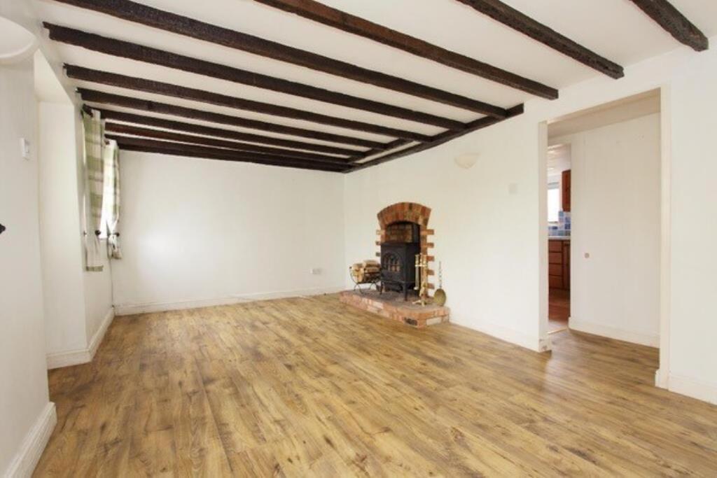 Lot: 78 - VACANT PERIOD COTTAGE - living room with beamed ceiling and fireplace